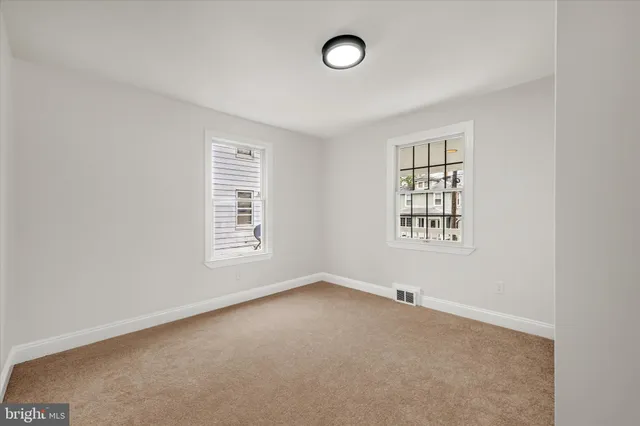 a kitchen with granite countertop white cabinets and sink