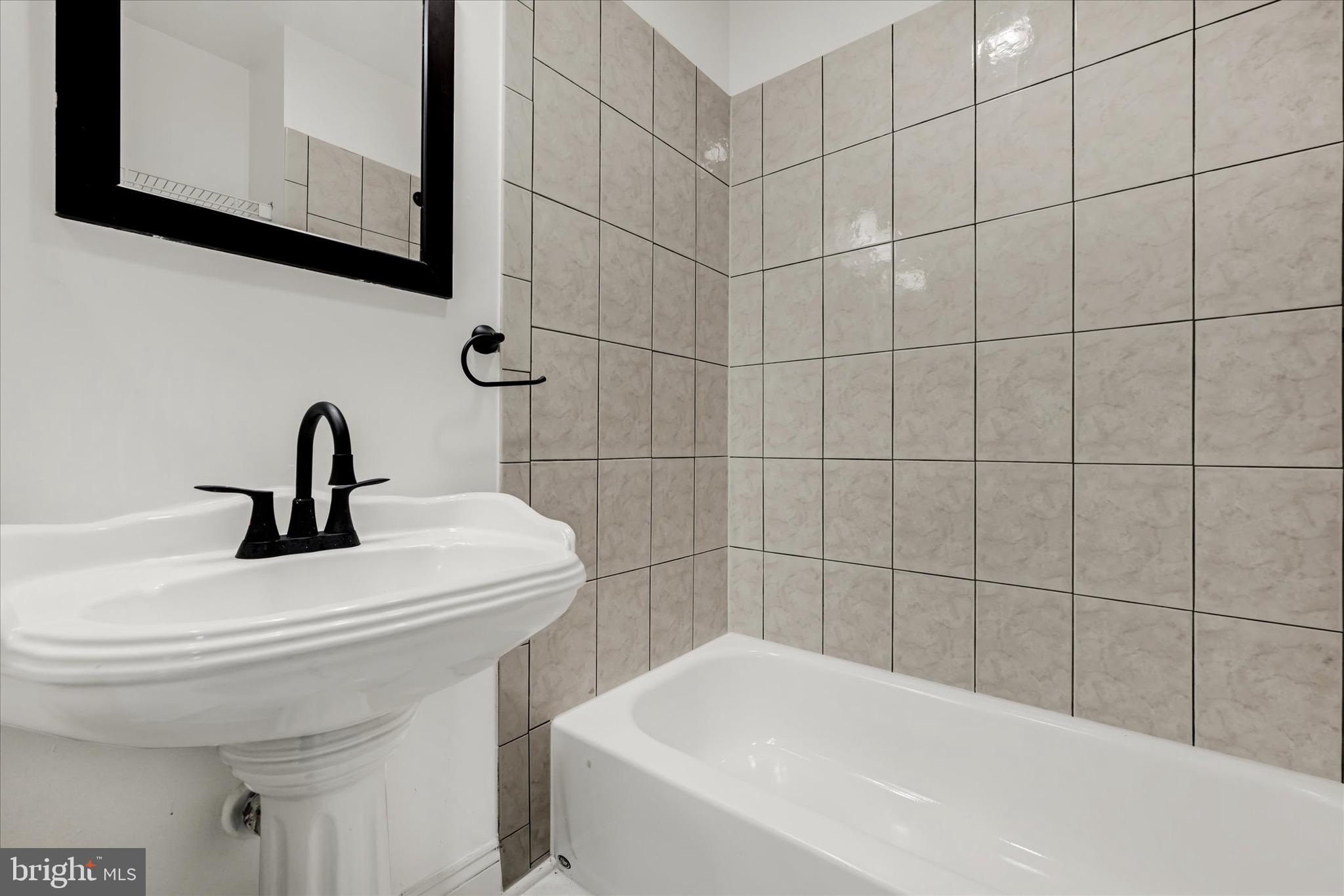2108 Sunbriar Road Baltimore, MD 21207 - Photo 37 of 50 a bathroom with a sink and a mirror