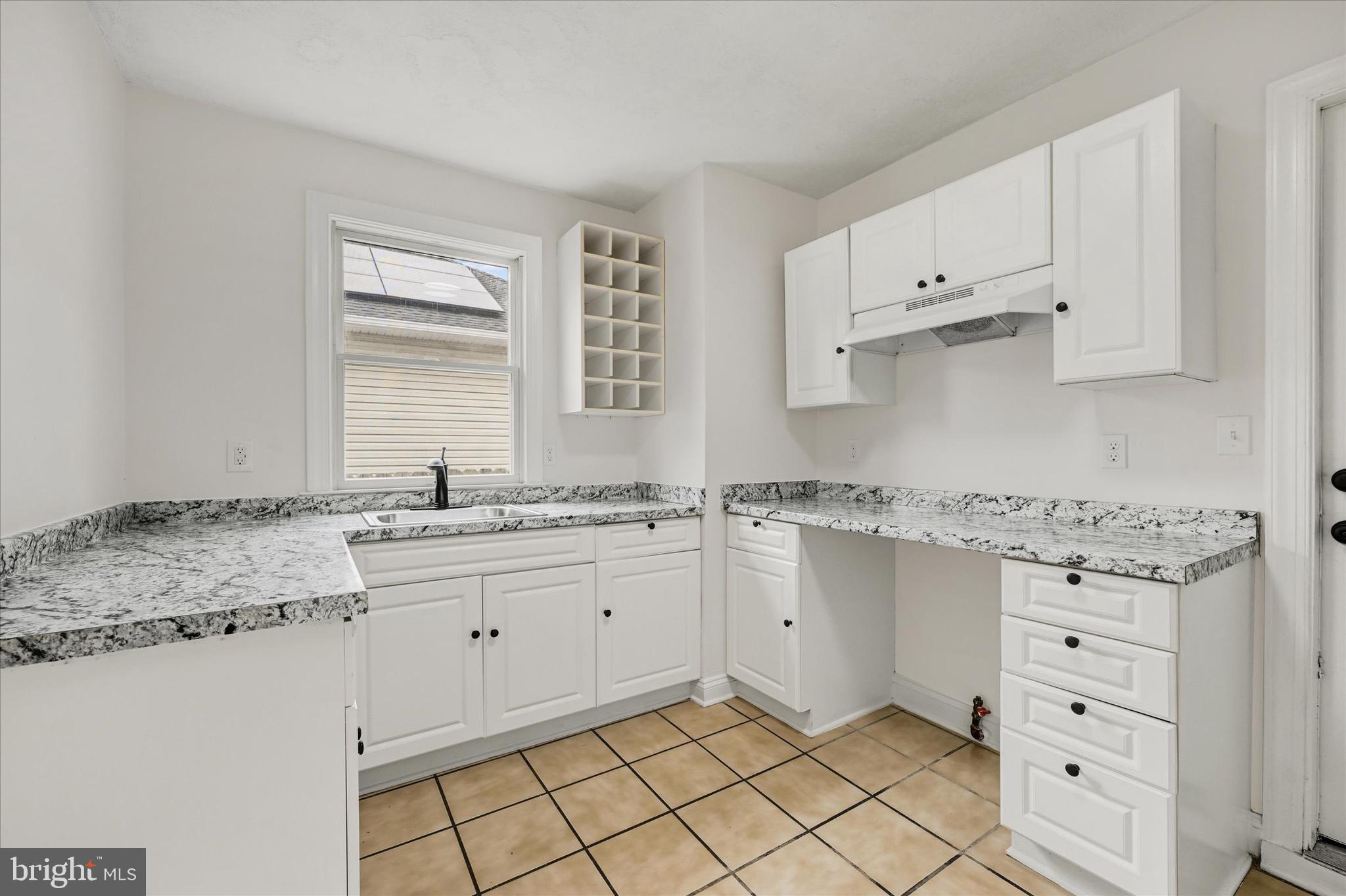 2108 Sunbriar Road Baltimore, MD 21207 - Photo 38 of 50 a kitchen with granite countertop white cabinets and sink