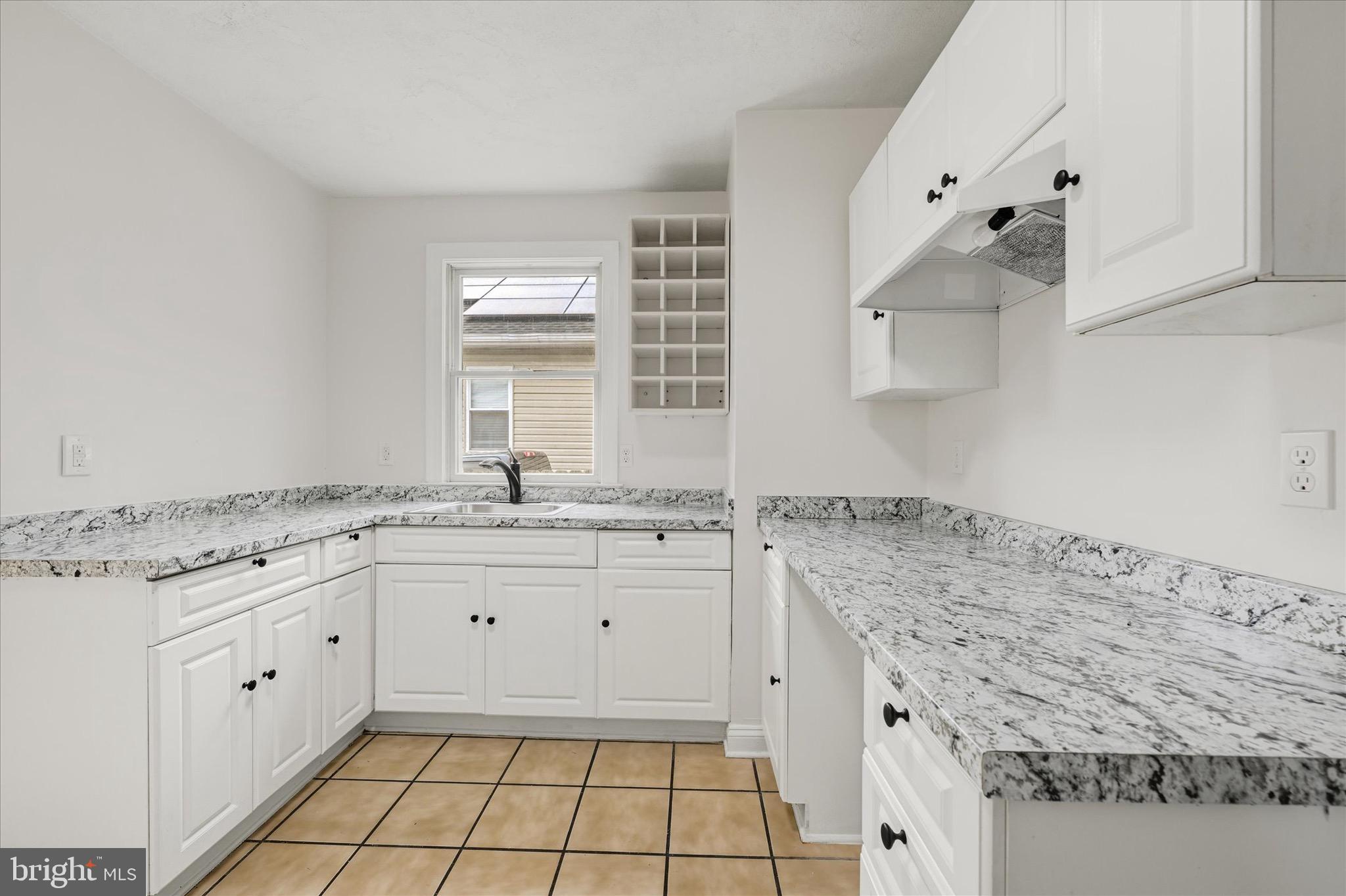 2108 Sunbriar Road Baltimore, MD 21207 - Photo 39 of 50 a kitchen with granite countertop a sink and a stove