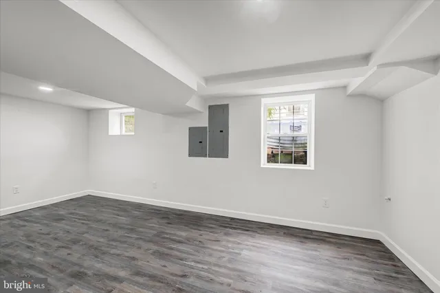 a view of a storage & utility room with closet and wooden floor