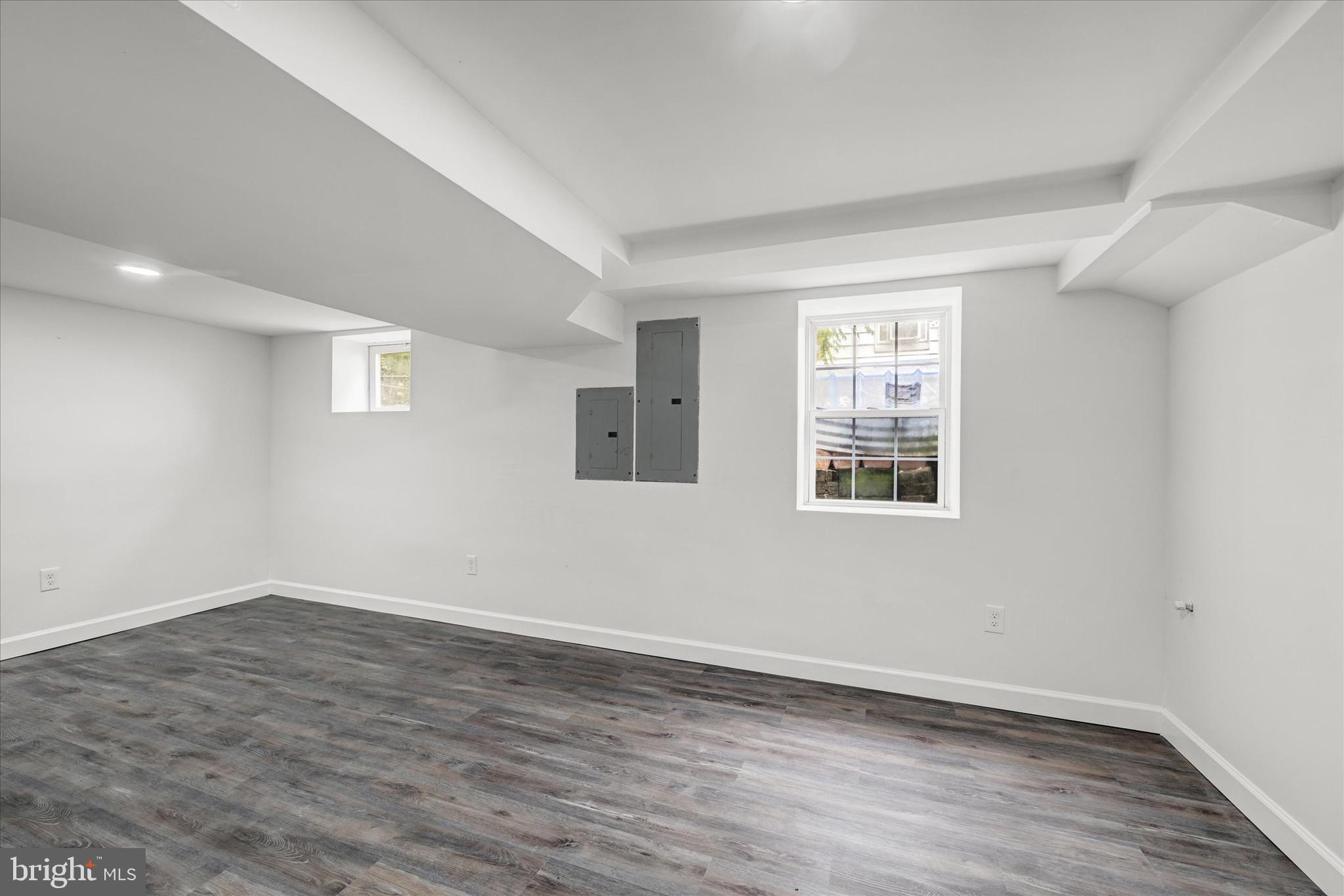 2108 Sunbriar Road Baltimore, MD 21207 - Photo 40 of 50 a view of an empty room with wooden floor and a window