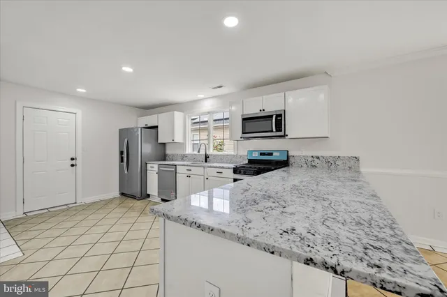 a kitchen with refrigerator and microwave