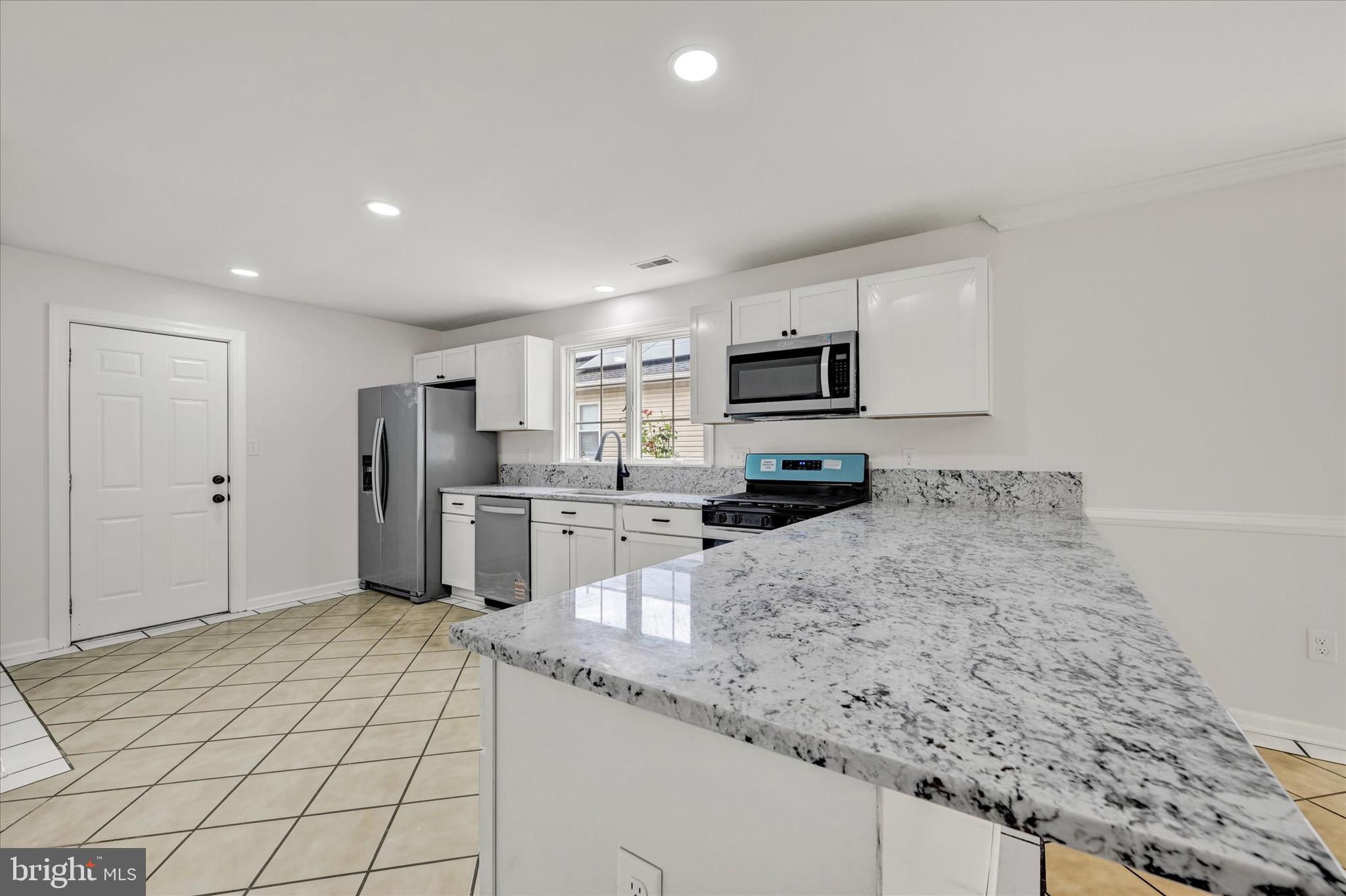 2108 Sunbriar Road Baltimore, MD 21207 - Photo 4 of 50 a kitchen with refrigerator and microwave