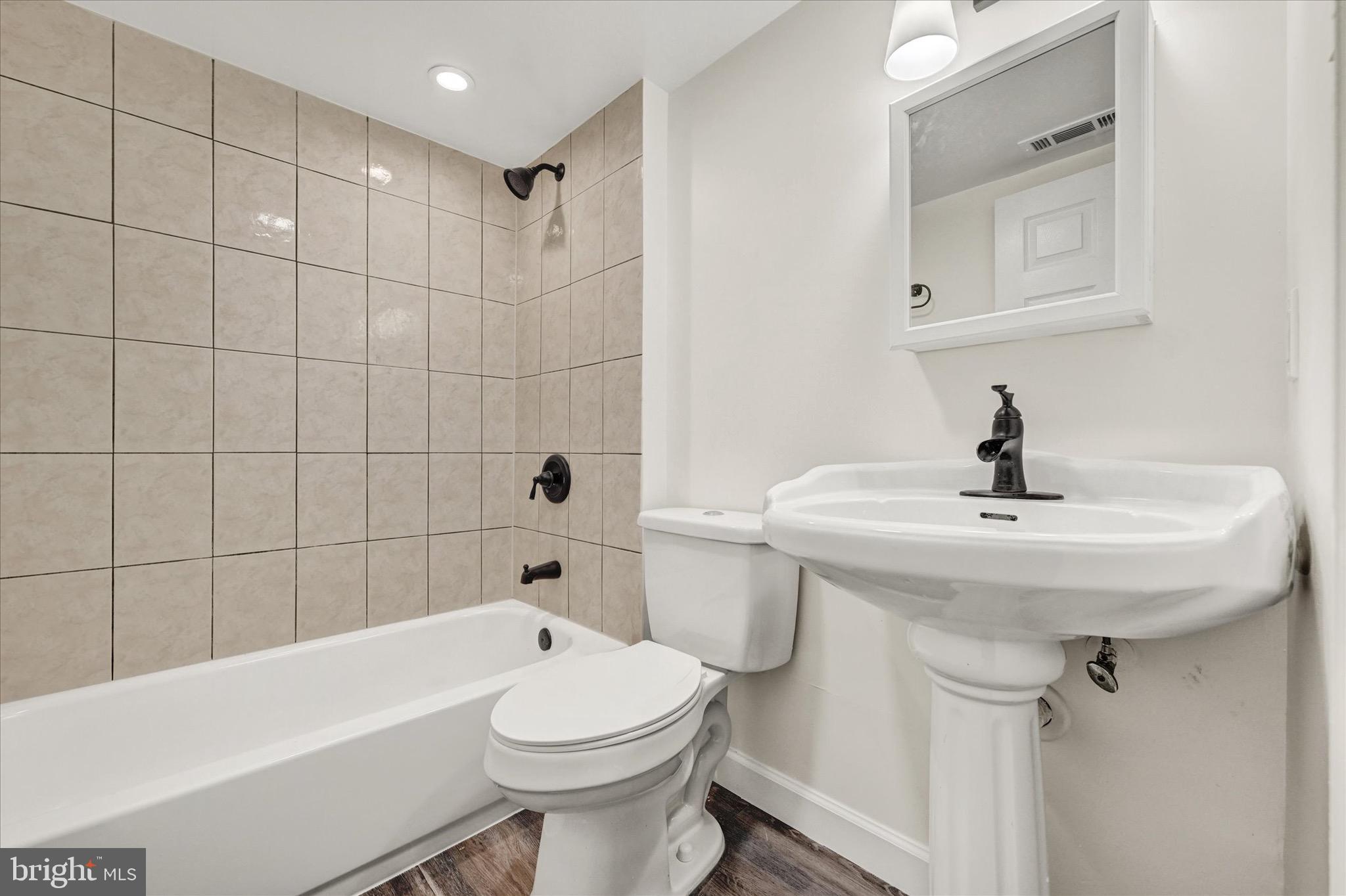 2108 Sunbriar Road Baltimore, MD 21207 - Photo 41 of 50 a bathroom with a sink a toilet and bathtub