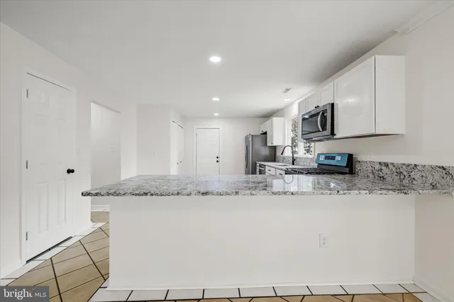 a kitchen with stainless steel appliances granite countertop a sink and cabinets