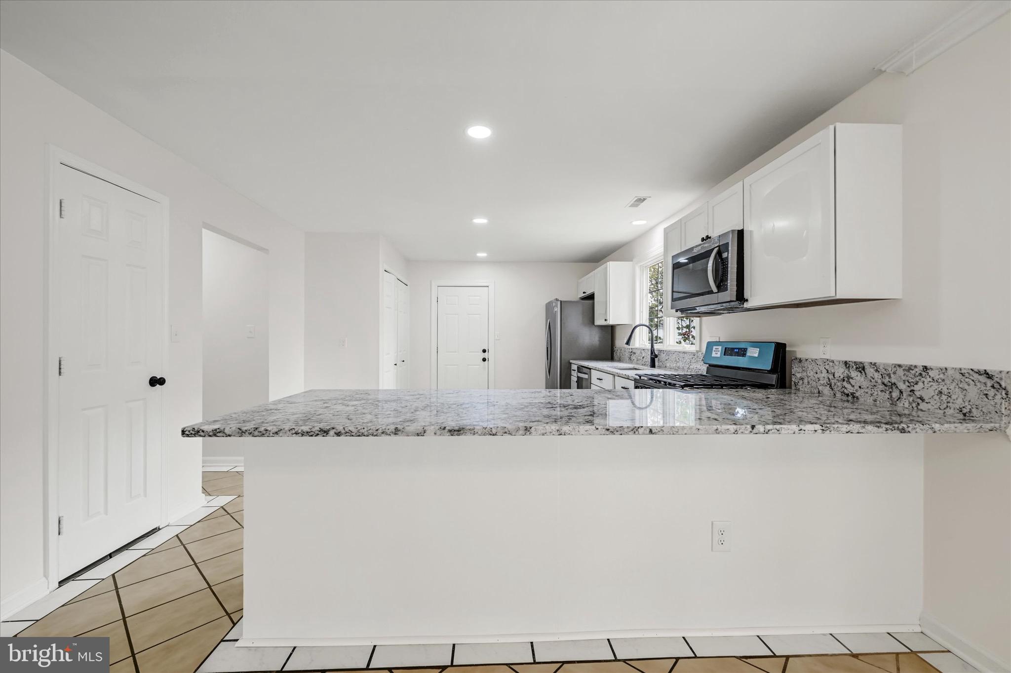 2108 Sunbriar Road Baltimore, MD 21207 - Photo 5 of 50 a kitchen with stainless steel appliances granite countertop a sink and cabinets