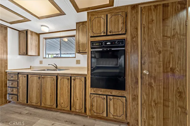 a kitchen with stainless steel appliances granite countertop a refrigerator and cabinets