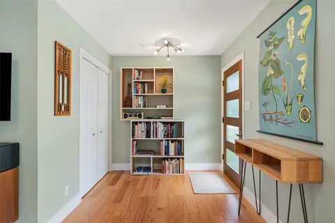 a view of a livingroom with furniture and book shelf