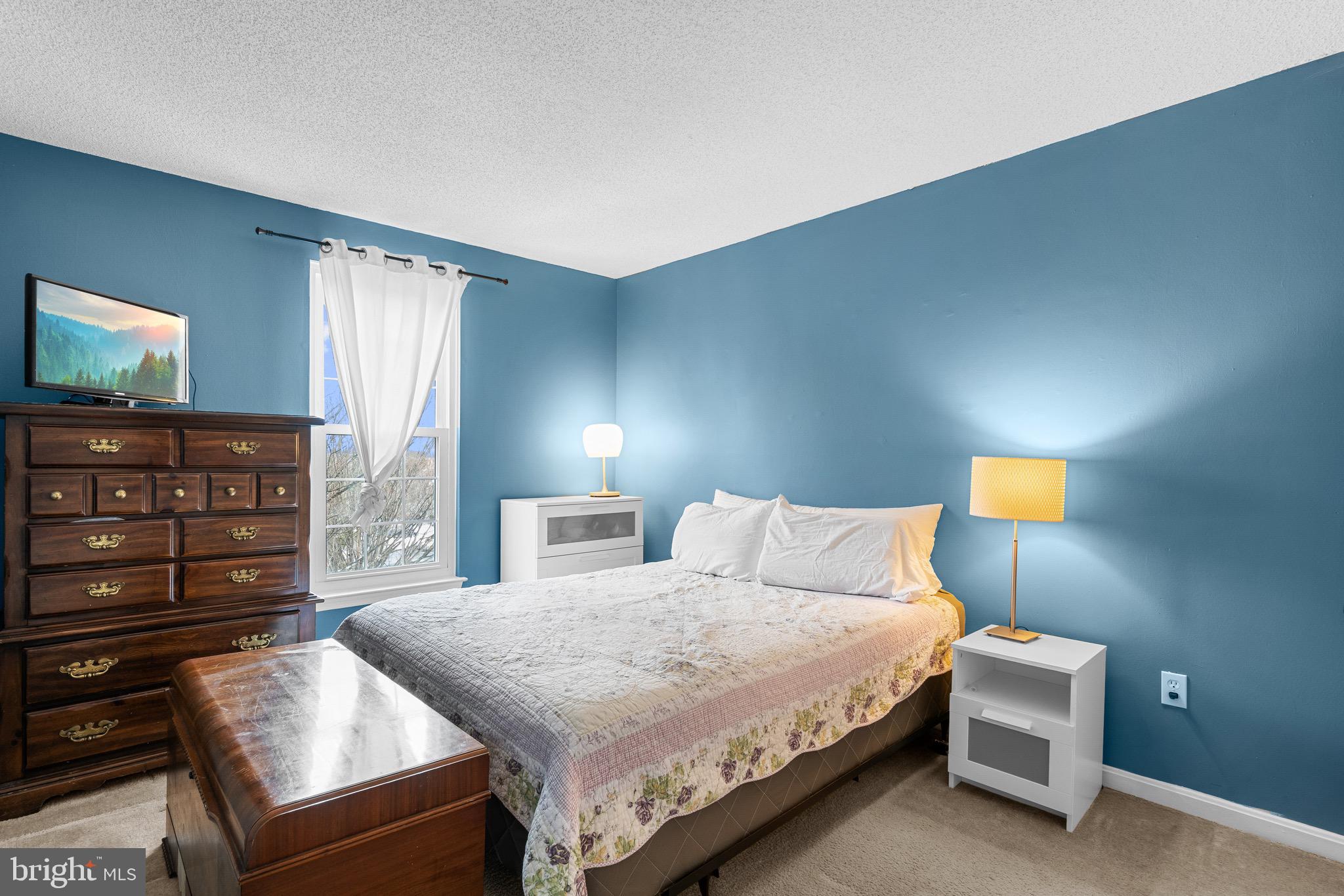 14010 Valleyfield Drive Silver Spring, MD 20906 - Photo 13 of 24 a bedroom with a bed and a television