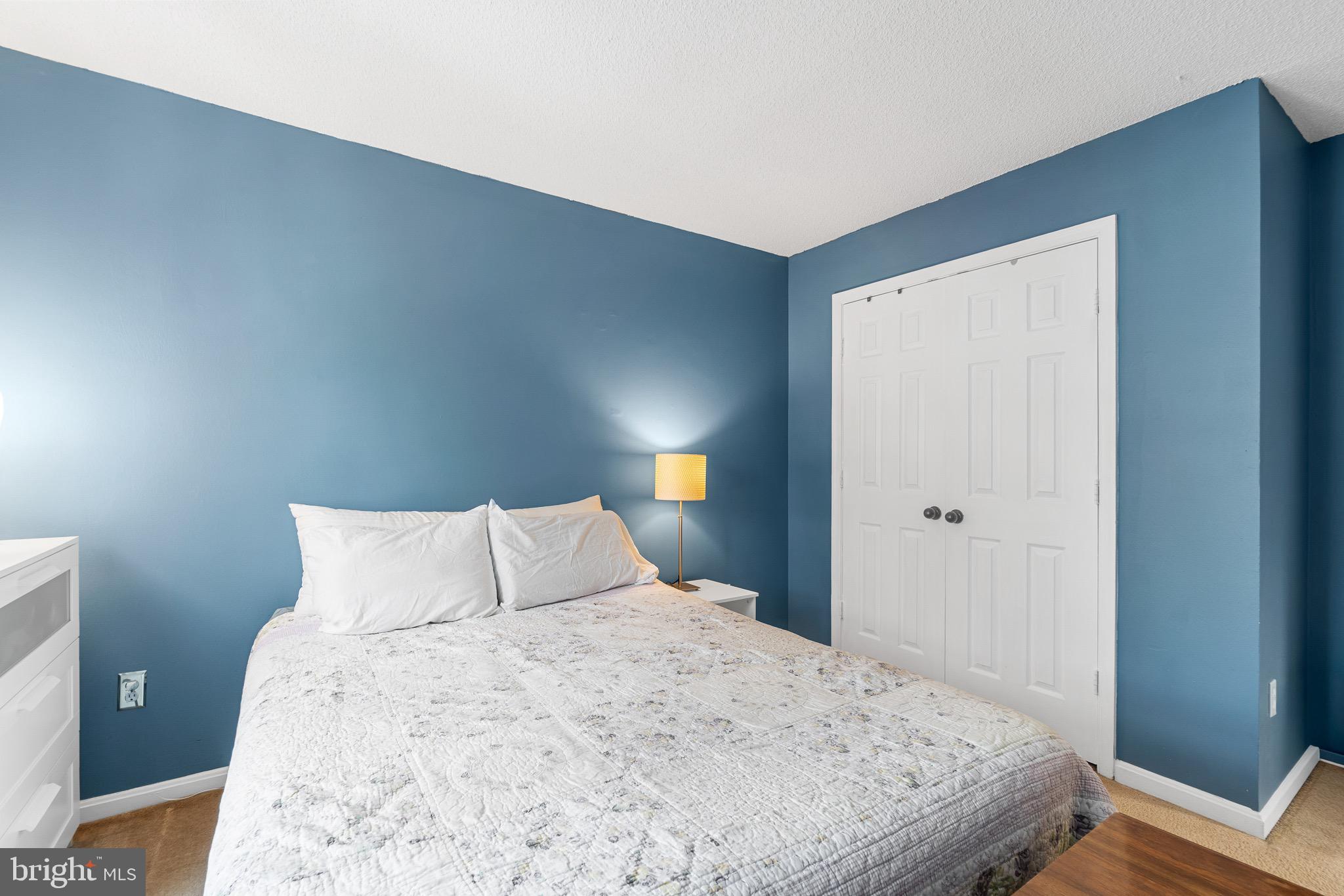 14010 Valleyfield Drive Silver Spring, MD 20906 - Photo 14 of 24 a bedroom with a bed and a lamp