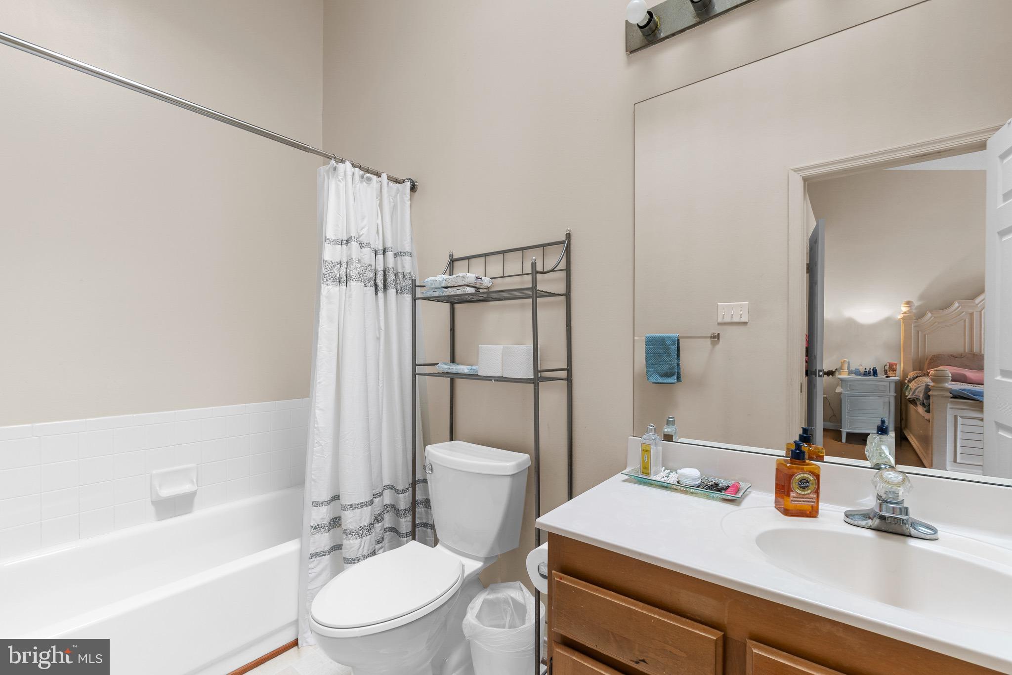 14010 Valleyfield Drive Silver Spring, MD 20906 - Photo 18 of 24 a bathroom with a sink a toilet and shower