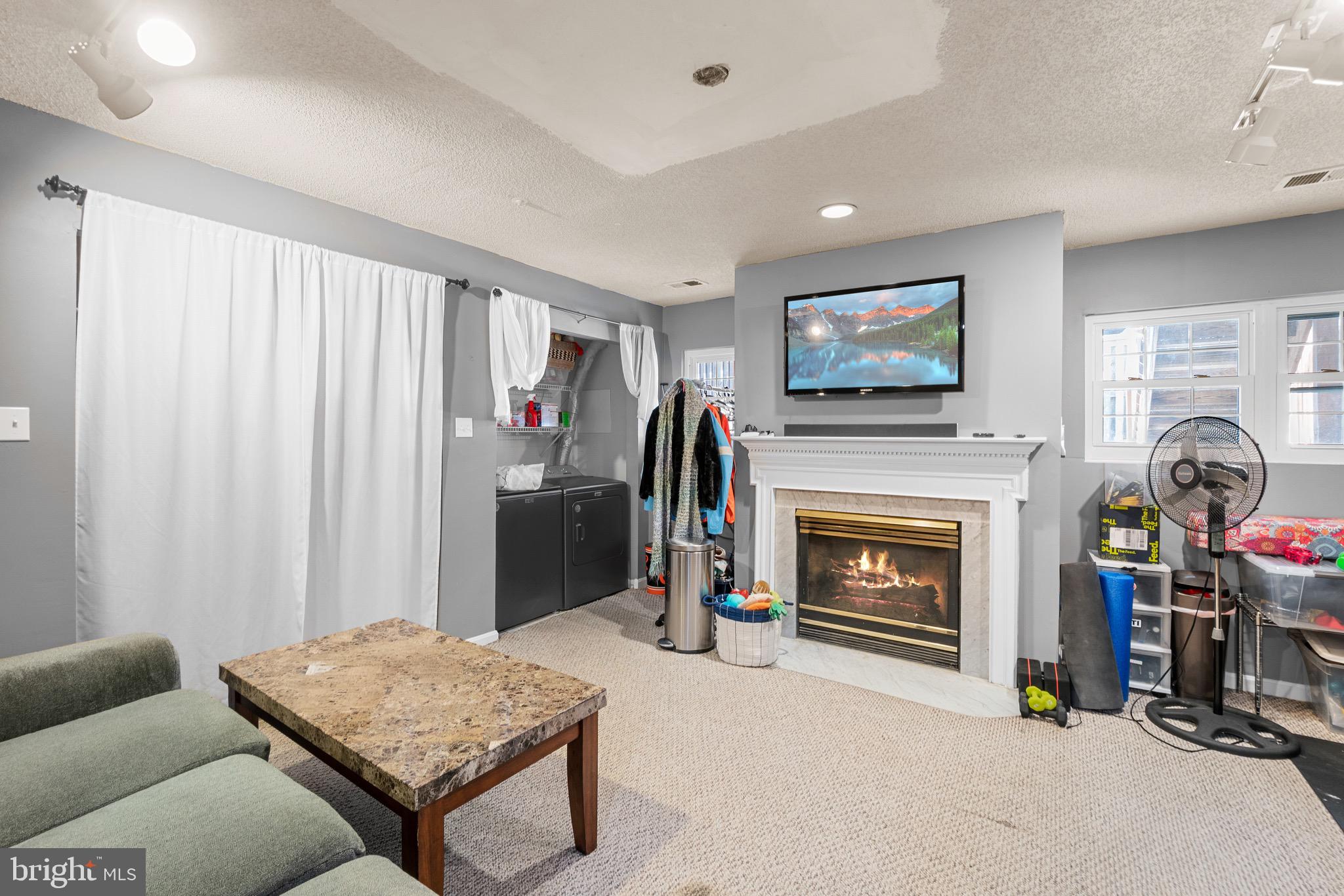 14010 Valleyfield Drive Silver Spring, MD 20906 - Photo 20 of 24 a living room with furniture and a fireplace