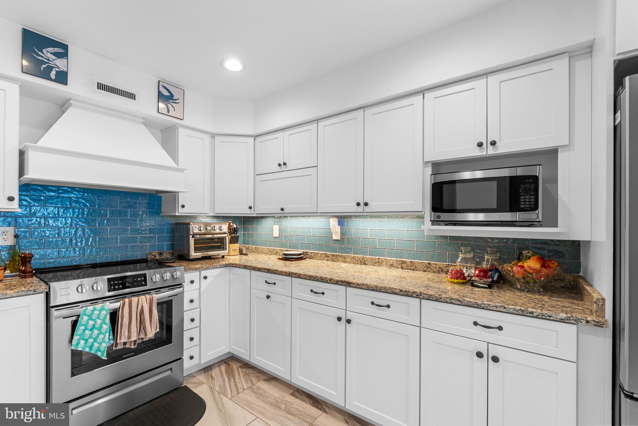 14010 Valleyfield Drive Silver Spring, MD 20906 - Photo 4 of 24 a kitchen with granite countertop white cabinets stainless steel appliances and sink