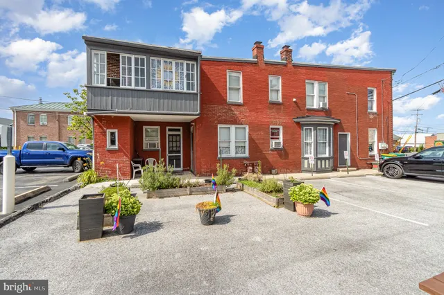 a front view of a house with outdoor seating