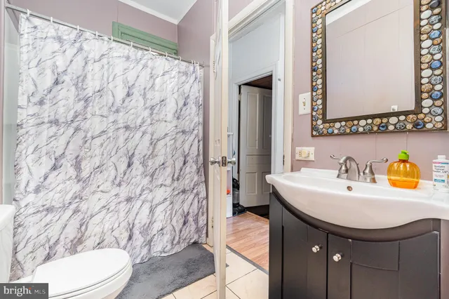 a bathroom with a sink toilet and mirror