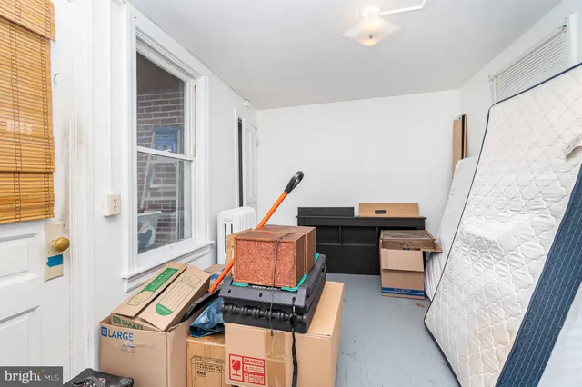 a living room with furniture stove and a window