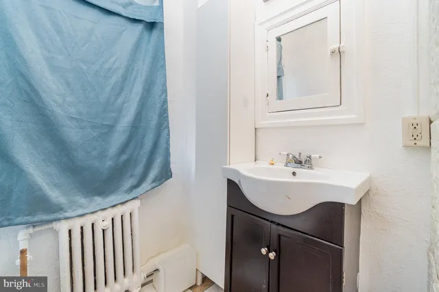 a bathroom with a sink a toilet and mirror