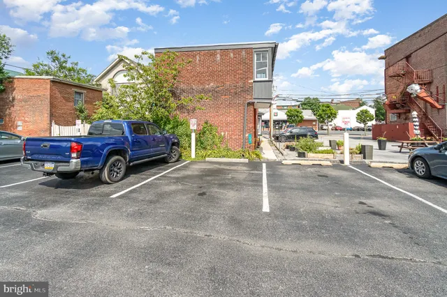 a view of a cars park in front of a building