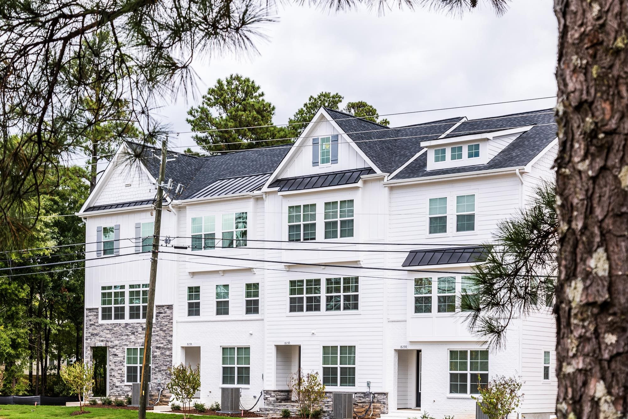 8236 Ebenezer Church Road Raleigh, NC 27613 - Photo 14 of 17 a view of a white building among the street with palm trees