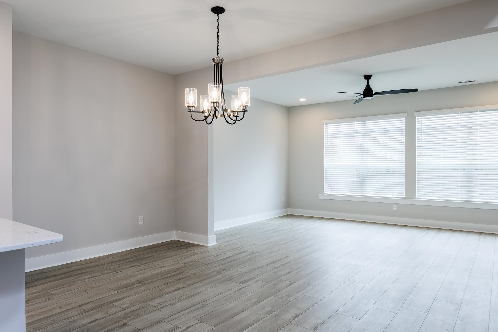 8236 Ebenezer Church Road Raleigh, NC 27613 - Photo 3 of 17 a view of an empty room with wooden floor and a window