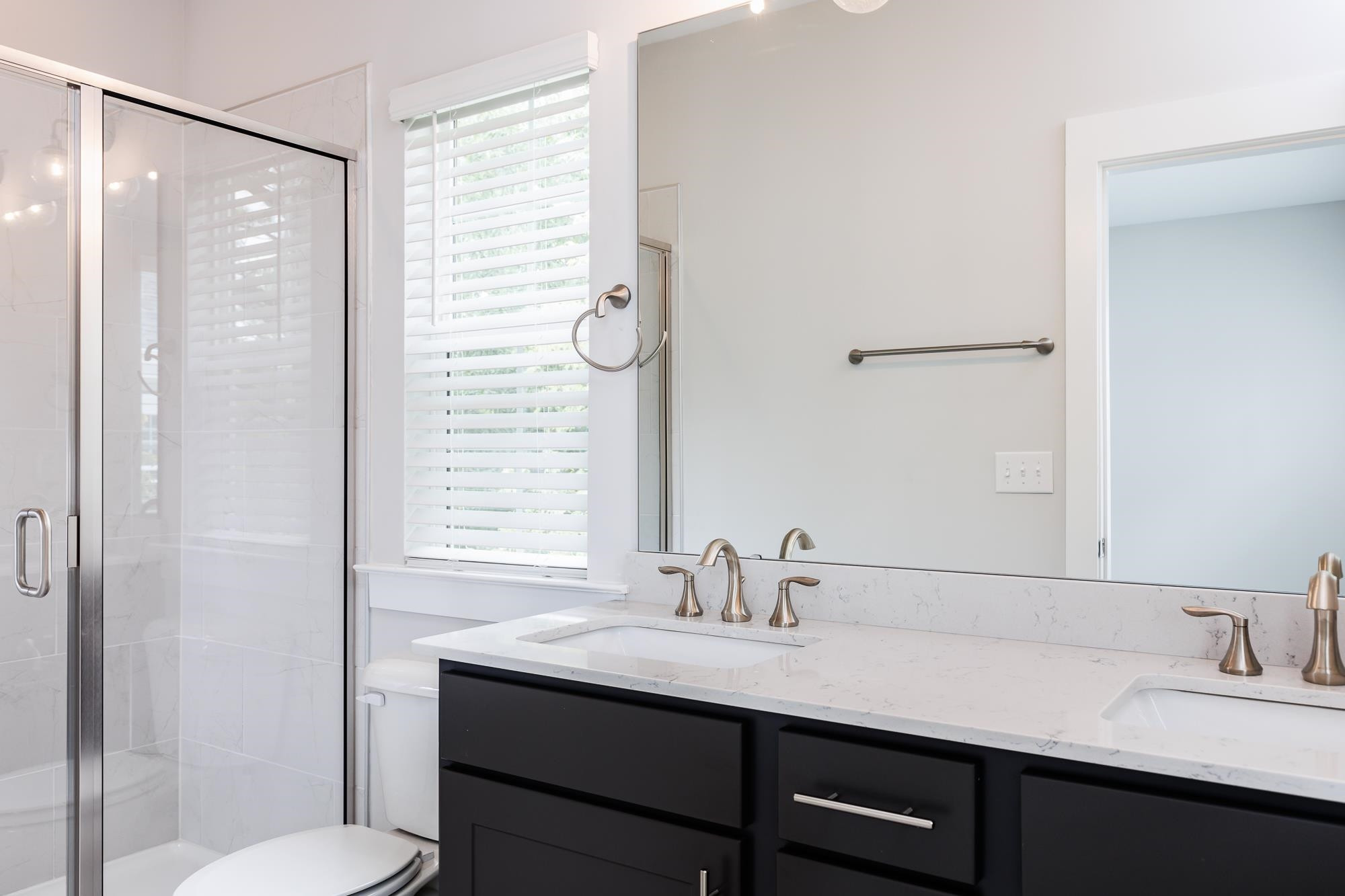 8236 Ebenezer Church Road Raleigh, NC 27613 - Photo 10 of 17 a bathroom with a granite countertop sink toilet and shower