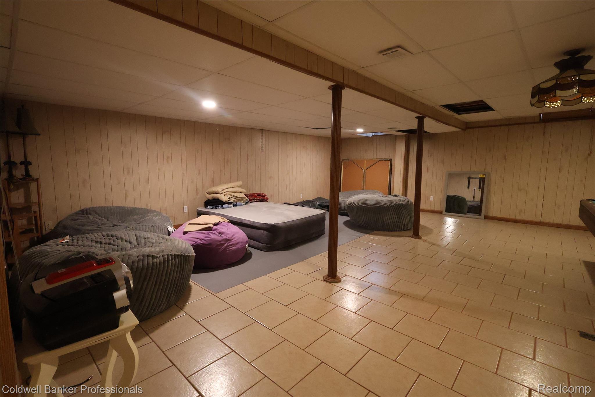 22305 King Road Trenton, MI 48183 - Photo 21 of 26 Bedroom featuring wooden walls, a drop ceiling, and light tile patterned floors