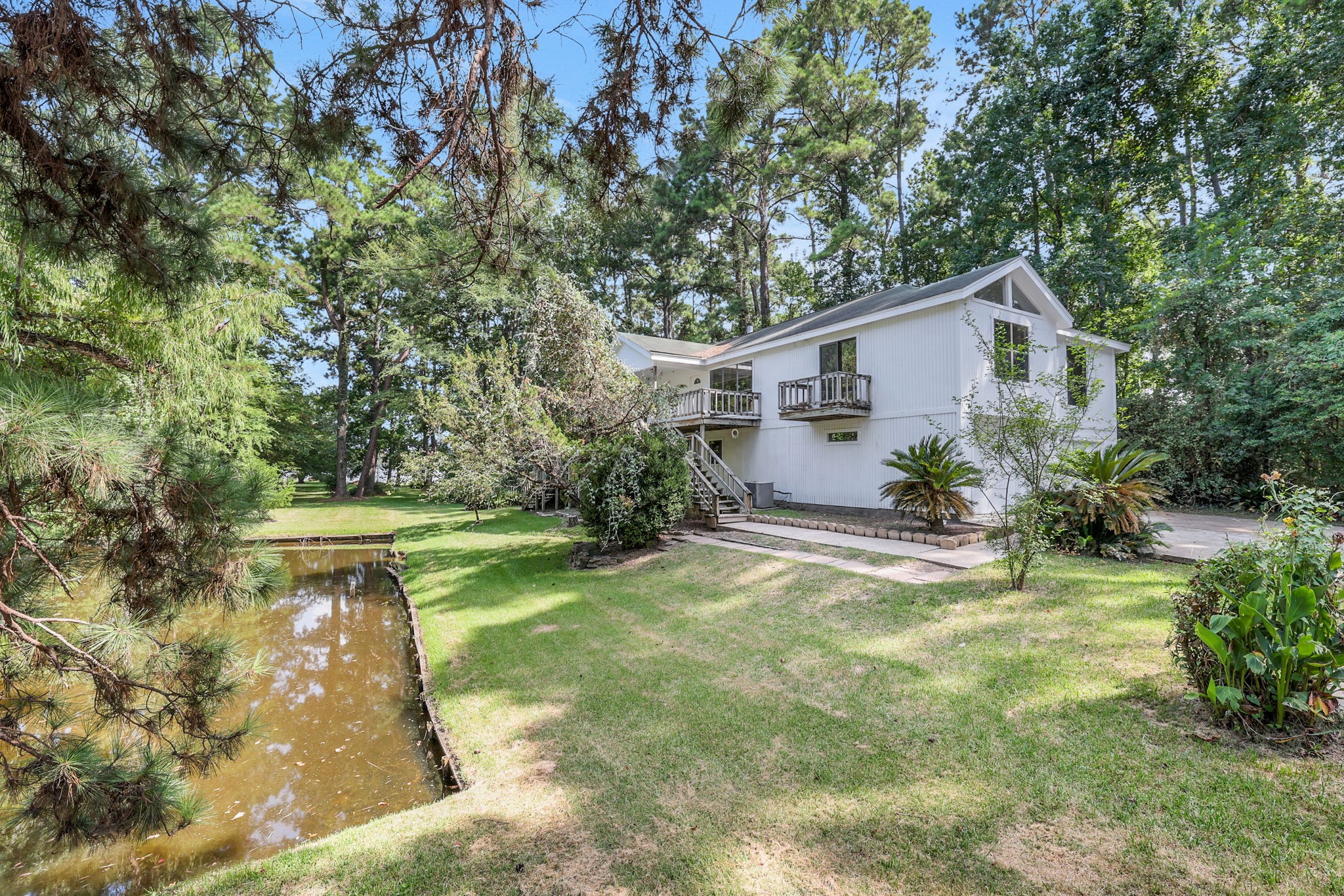 200 Johnson Road Coldspring, TX 77331 - Photo 3 of 47 The home sits alongside a peaceful pond