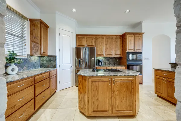 a large kitchen with a large window and counter space