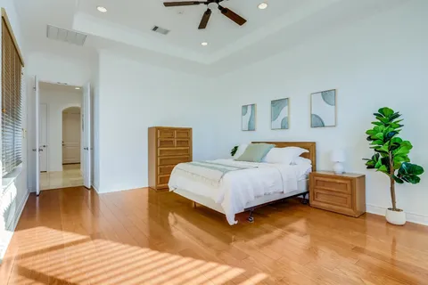 a bedroom with a bed and ceiling fan