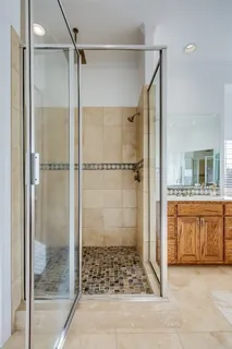 a bathroom with a granite countertop shower mirror and a sink