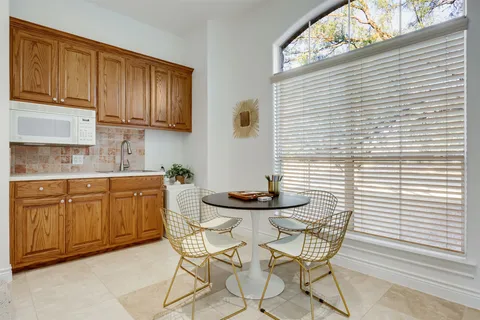 a kitchen with stainless steel appliances kitchen island granite countertop wooden cabinets