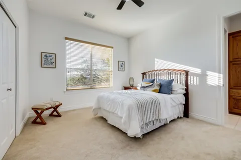 a bedroom with a bed a table and a window