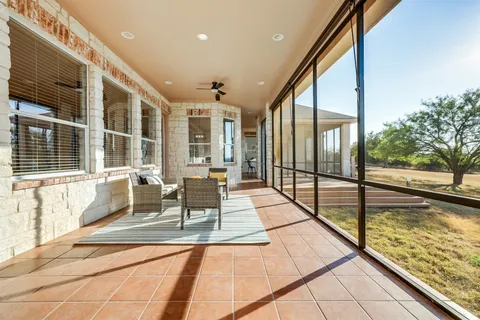 a view of swimming pool with a table and chairs