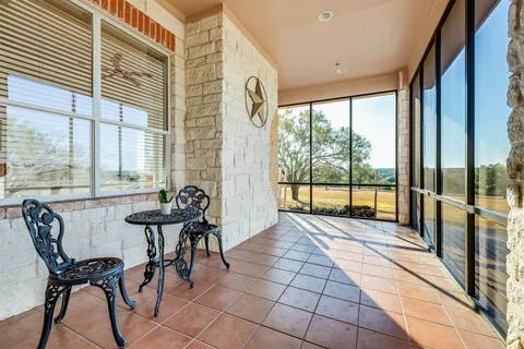 a view of a dining room with furniture large windows and wooden floor