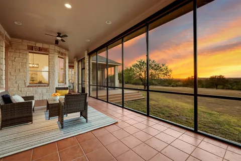 a living room with glass door and furniture
