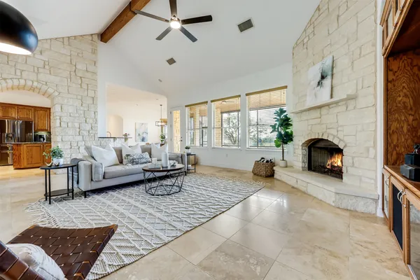 a dining hall with stainless steel appliances granite countertop a stove and a refrigerator