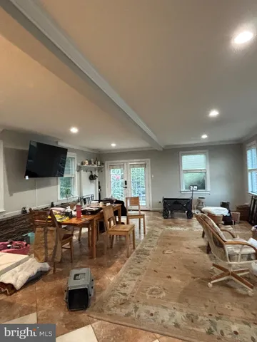 a living room with lots of furniture and a flat screen tv