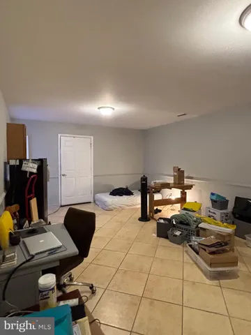 a living room with furniture and a piano