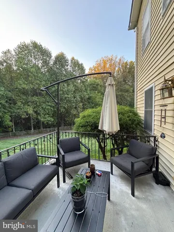 a roof deck with couches and potted plants