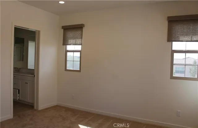 a view of an empty room and a bathroom