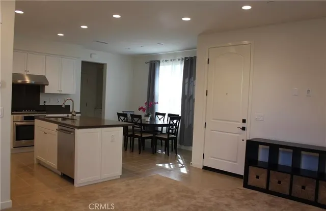 a kitchen with a refrigerator and a sink