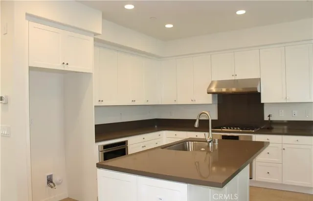 a stove top oven sitting inside of a kitchen