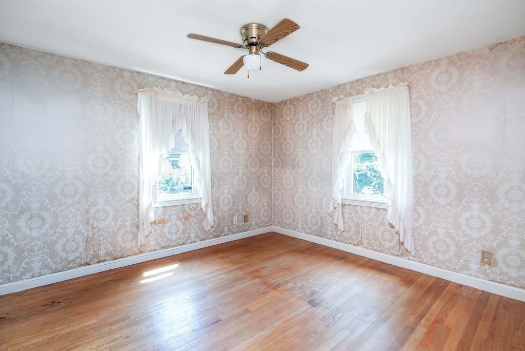 5 Clough Street Springfield, MA 01118 - Photo 12 of 26 an empty room with wooden floor and windows
