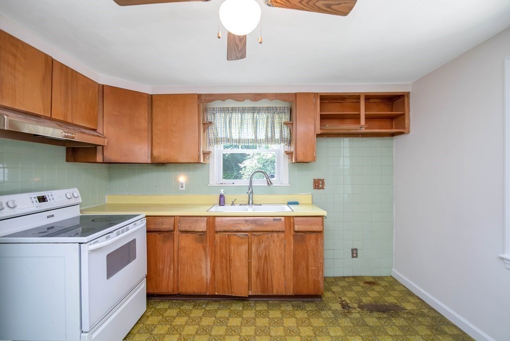 5 Clough Street Springfield, MA 01118 - Photo 6 of 26 a kitchen with a sink stove and cabinets