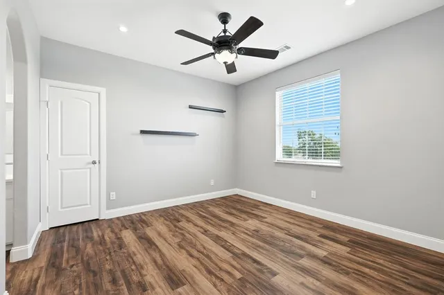 a view of walk in closet with empty racks