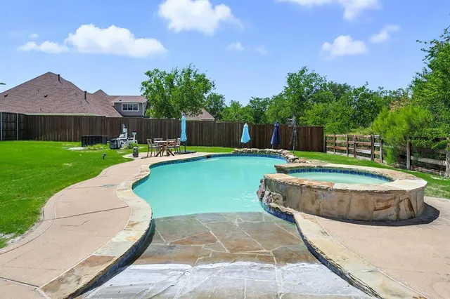a view of a swimming pool with a yard