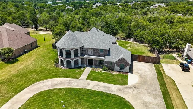 an aerial view of a house with yard swimming pool and outdoor seating