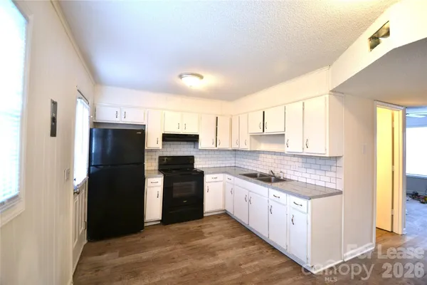 a kitchen with stainless steel appliances granite countertop a stove and a refrigerator