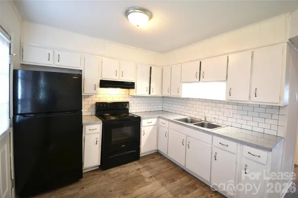 a kitchen with a refrigerator stove and sink